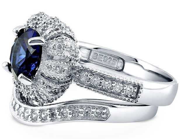 Metal: 925 sterling silver, rhodium plated, nickel free Main Stone: round cut simulated blue sapphire cubic zirconia (2.04 ct.tw; 8mm) Accent Stone: cubic zirconia (0.66 ct.tw) Band Width: 5.75mm
